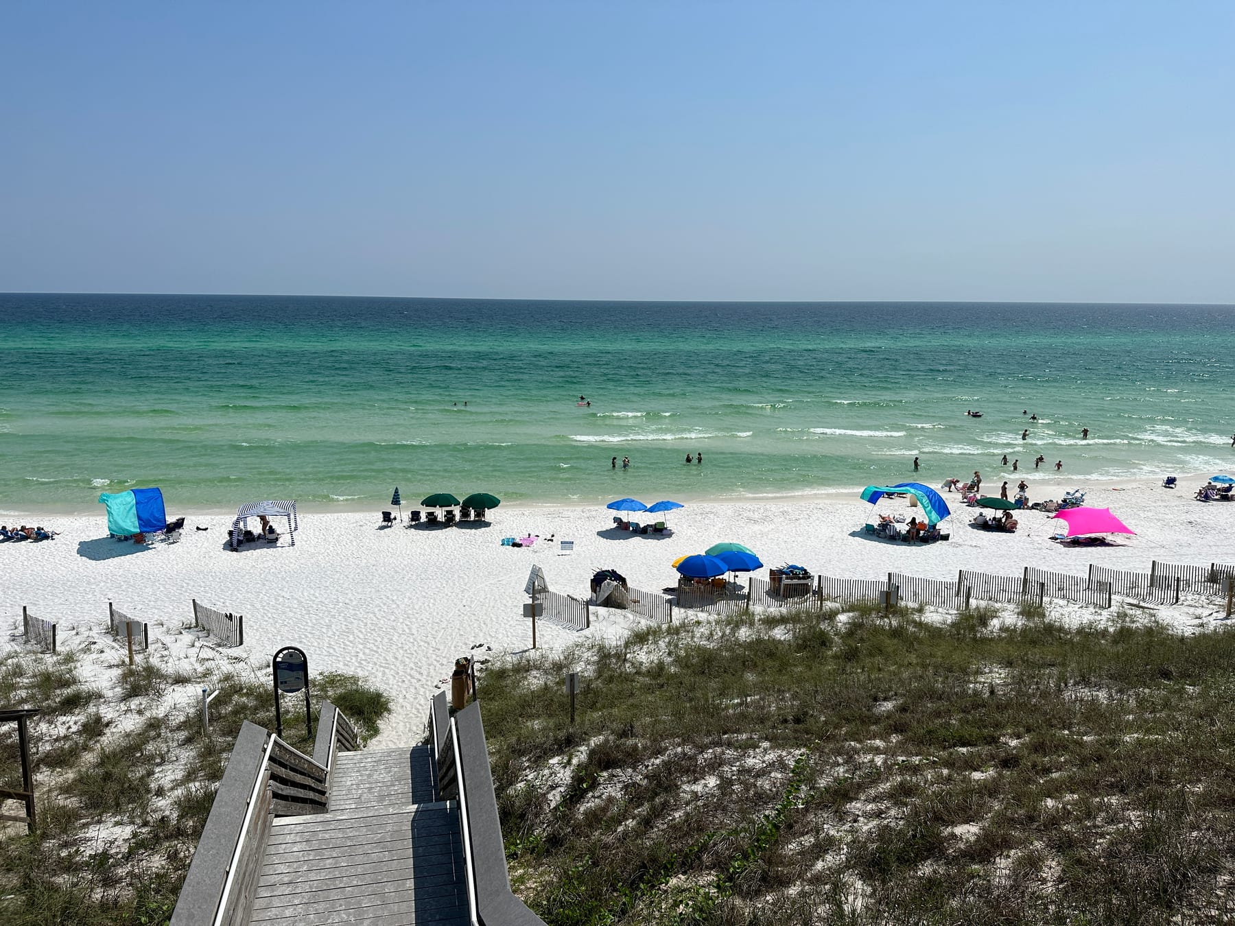Sugar-white sand and turquoise gulf water at Greenwood Beach Access, mid-July afternoon